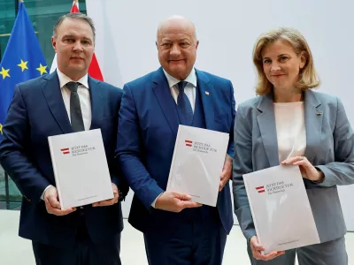 Head of People's Party (OeVP) Christian Stocker, head of Social Democrats Andreas Babler and head of NEOS party Beate Meinl-Reisinger pose with copies of the program, after finalizing coalition talks, at the Parliament in Vienna, Austria, February 27, 2025. REUTERS/Lisa Leutner  TPX IMAGES OF THE DAY