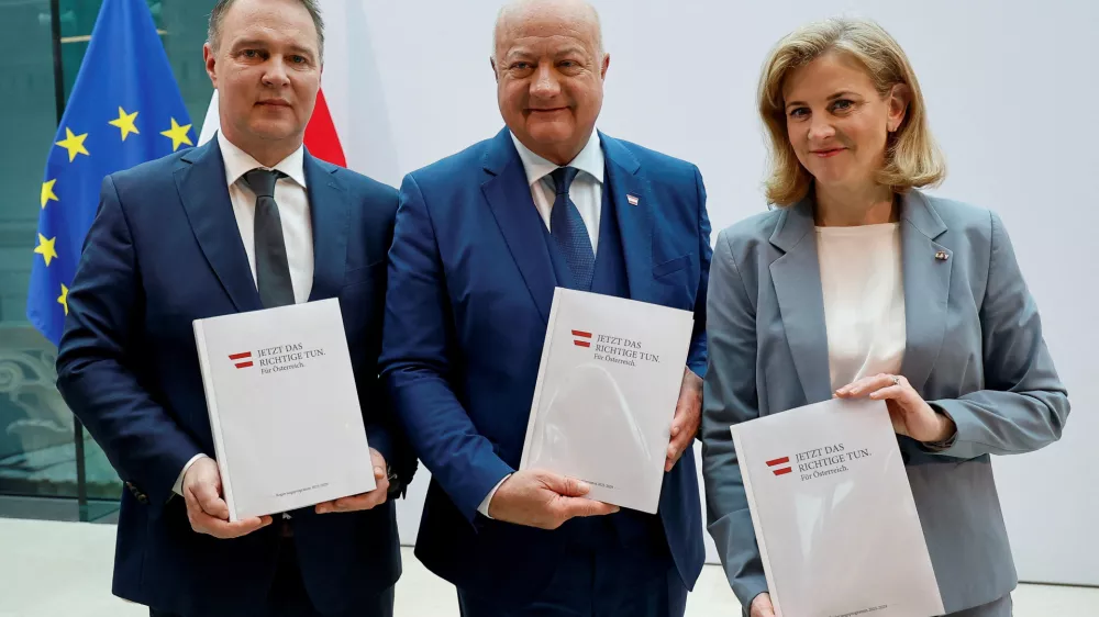 Head of People's Party (OeVP) Christian Stocker, head of Social Democrats Andreas Babler and head of NEOS party Beate Meinl-Reisinger pose with copies of the program, after finalizing coalition talks, at the Parliament in Vienna, Austria, February 27, 2025. REUTERS/Lisa Leutner  TPX IMAGES OF THE DAY