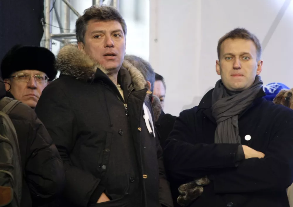 FILE - From left, Russian former Financial Minister Alexei Kudrin, leaders of the opposition Boris Nemtsov and Alexei Navalny attend a rally to protest alleged vote rigging in Russia's parliamentary elections on Sakharov avenue in Moscow, Russia on Dec. 24, 2011. Russia's prison agency says that imprisoned opposition leader Alexei Navalny has died. He was 47. The Federal Prison Service said in a statement that Navalny felt unwell after a walk on Friday Feb. 16, 2024 and lost consciousness. (AP Photo/Misha Japaridze, File)