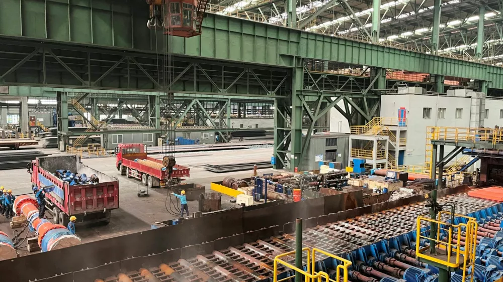 FILE PHOTO: Employees work on the production line at a Baowu Group steel mill in Ezhou, Hubei province, China June 21, 2023. REUTERS/Amy Lv/File Photo