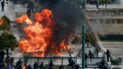 People gather next to fire during clashes, near the Greek parliament at a protest, marking the second anniversary of the country's worst railway disaster, while an investigation continues, in Athens, Greece, February 28, 2025. REUTERS/Louiza Vradi     TPX IMAGES OF THE DAY