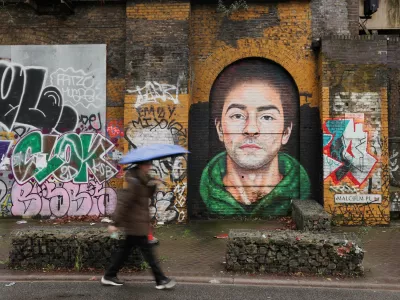 A pedestrian walks past a mural of Luigi Mangione, the suspect in the killing of UnitedHealth Group chief executive Brian Thompson, in East London, Britain February 26, 2025. REUTERS/Temilade Adelaja