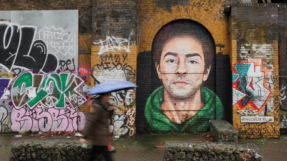 A pedestrian walks past a mural of Luigi Mangione, the suspect in the killing of UnitedHealth Group chief executive Brian Thompson, in East London, Britain February 26, 2025. REUTERS/Temilade Adelaja