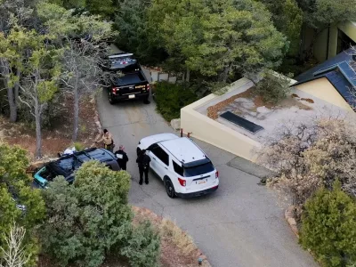 Law enforcement officials talk outside the home of actor Gene Hackman on Thursday, Feb. 27, 2025 in Santa Fe, New Mexico. Hackman, his wife Betsy Arakawa and their dog were found dead in the home a day earlier. (AP Photo/Roberto Rosales)