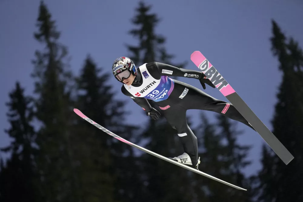 Marius Lindvik, of Norway, soars through the air during his first round jump of the ski jumping men's normal hill HS102 event at the Nordic World Ski Championships in Trondheim, Norway, Sunday, March 2, 2025. (AP Photo/Matthias Schrader)