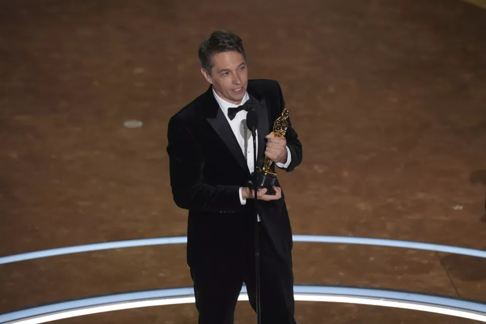 Sean Baker accepts the award for best original screenplay for "Anora" during the Oscars on Sunday, March 2, 2025, at the Dolby Theatre in Los Angeles. (AP Photo/Chris Pizzello)