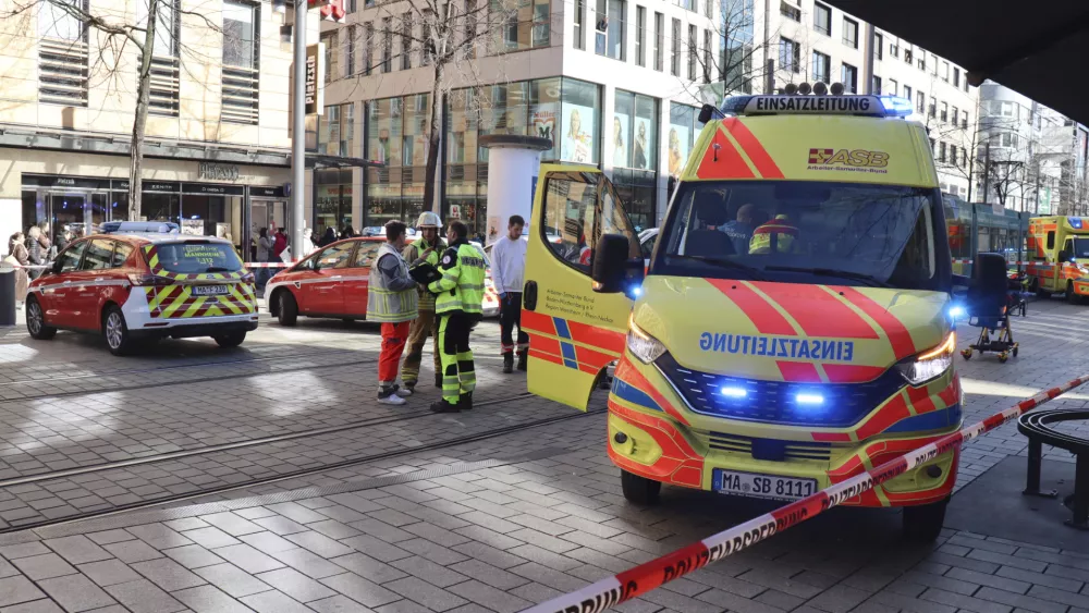 Emergency services and police stand at Paradeplatz in Mannheim, Germany, Monday March 3, 2025, after a driver driver drove into a group of people in a pedestrian street in Mannheim, killing one person and injuring others, Germany police said. (René Priebe/dpa via AP)(René Priebe/dpa via AP)
