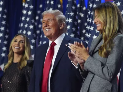 Republican presidential nominee former President Donald Trump stands on stage with former first lady Melania Trump, as Lara Trump watches, at an election night watch party at the Palm Beach Convention Center, Wednesday, Nov. 6, 2024, in West Palm Beach, Fla. (AP Photo/Evan Vucci)
