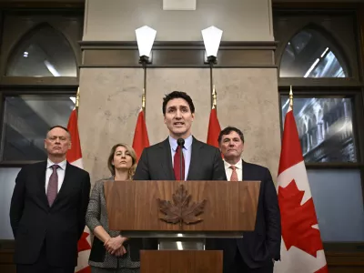 Canada's Prime Minister Justin Trudeau addresses media following the imposition of a raft of tariffs by U.S. President Donald Trump against Canada, Mexico and China, in Ottawa, Saturday, Feb. 1, 2025. Minister of Public Safety David McGuinty, left to right, Global Affairs Minister Melanie Joly and Minister of Governmental Affairs Dominic LeBlanc look on. (Justin Tang/The Canadian Press via AP)