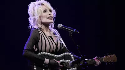 FILE - Dolly Parton performs during an event celebrating the Kansas statewide expansion of Dolly Parton's Imagination Library Monday, Aug. 14, 2023, in Overland Park, Kan. Carl Dean, Dolly Parton's husband of nearly 60 years, died Monday, March 3, 2025, in Nashville, Tenn., at age 82. (AP Photo/Charlie Riedel, File)