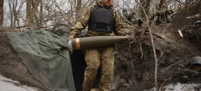 An Ukrainian serviceman carries a shell to fire a M777 howitzer towards Russian positions at the frontline near Donetsk, Ukraine, Sunday, March, 2, 2025. (AP Photo/Roman Chop)