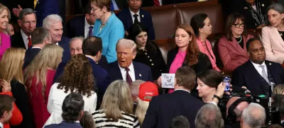 U.S. President Donald Trump attends a joint session of Congress as Rep. Melanie Stansbury (D-NM) holds a sign reading "This is not normal", in the House Chamber of the U.S. Capitol in Washington, D.C., U.S., March 4, 2025. REUTERS/Evelyn Hockstein