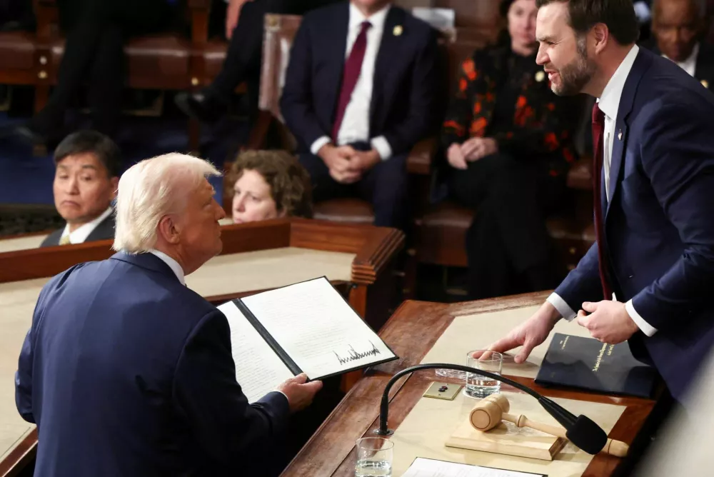 U.S. President Donald Trump holds a copy of an executive order honoring Jocelyn Nungaray, next to U.S. Vice President JD Vance, during a joint session of Congress, in the House Chamber of the U.S. Capitol in Washington, D.C., U.S., March 4, 2025. REUTERS/Evelyn Hockstein