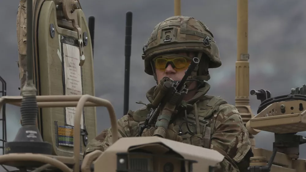 FILE - A British soldier with NATO-led Resolute Support Mission forces arrives at the site of an attack in Kabul, Afghanistan, Wednesday, March 25, 2020. The U.K. government said Wednesday it has no plans to introduce conscription, after the head of the British Army said a "citizen army" would be needed to fight a future war with a country like Russia. (AP Photo/Rahmat Gul, File)