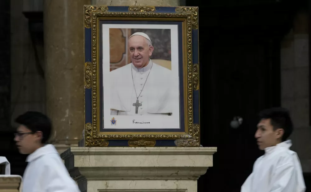 A photo of Pope Francis adorns a wall during Ash Wednesday Mass at the Cathedral of Our Lady of La Paz, Bolivia, Wednesday, March 5, 2025. (AP Photo/Juan Karita)