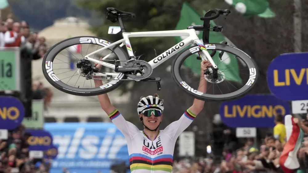 Reigning World Champion Slovenia's Tadej Pogacar holds up his bike as he celebrates winning Il Lombardia, Tour of Lombardy cycling race, in Como, Italy, Saturday, Oct. 12, 2024. (Gian Mattia D'Alberto/LaPresse via AP)