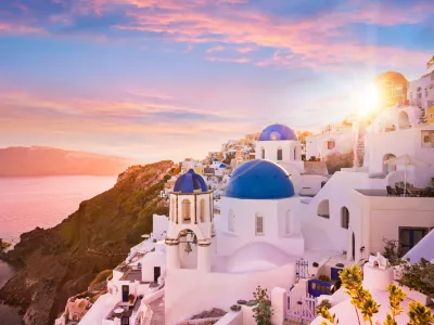 Sunset view of the blue dome churches of Santorini, Greece, Europe.