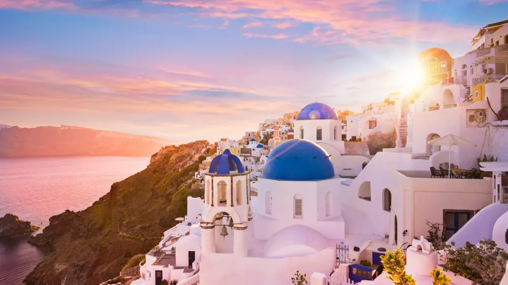 Sunset view of the blue dome churches of Santorini, Greece, Europe.