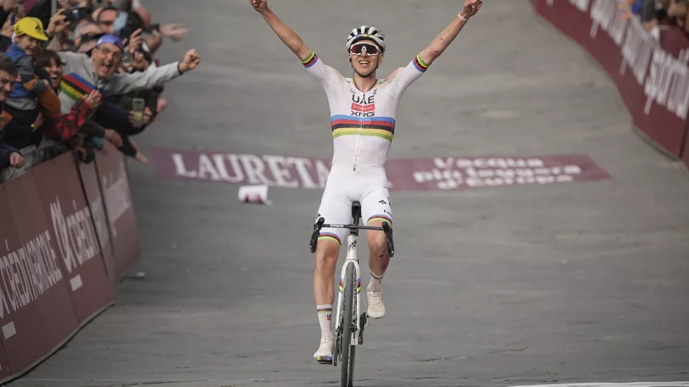 Tadej Pogacar, of Slovenia, celebrates winning 19th edition of the Strade Bianche (White Roads), a 213 km (132-mile) one-day race route through Tuscany, Saturday March 8, 2025, in Siena, Italy,. (Marco AlpozziLaPresse via AP)