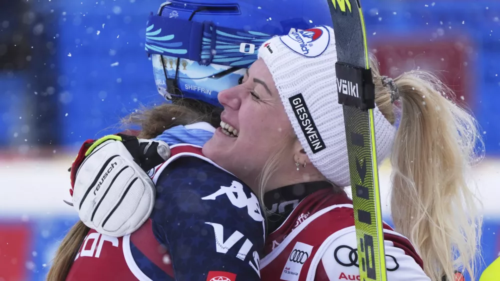 United States' Mikaela Shiffrin, left, third placed, embraces Austria's Katharina Truppe, the winner, after completing an alpine ski, women's World Cup slalom in Are, Sweden, Sunday, March 9, 2025. (AP Photo/Giovanni Auletta)