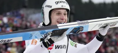 Domen Prevc, of Slovenia, celebrates after winning the gold medal in the ski jumping men's large hill individual competition at the Nordic World Ski Championships in Trondheim, Norway, Saturday, March 8, 2025. (AP Photo/Matthias Schrader)