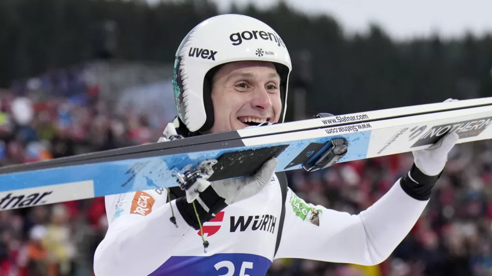 Domen Prevc, of Slovenia, celebrates after winning the gold medal in the ski jumping men's large hill individual competition at the Nordic World Ski Championships in Trondheim, Norway, Saturday, March 8, 2025. (AP Photo/Matthias Schrader)