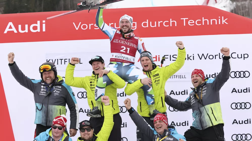 Third placed Slovenia's Miha Hrobat celebrates with the team after an alpine ski, men's World Cup downhill, in Kvitfjell, Norway, Saturday, March 8, 2025. (AP Photo/Marco Trovati)