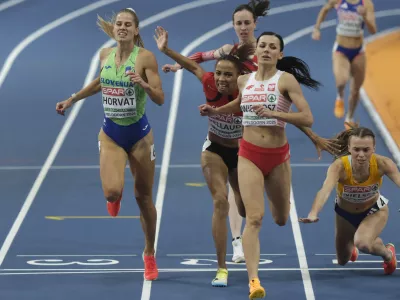 Slovenia's Anita Horvat, left, and Poland's Anna Wielgosz, center cross the finish line while Sweden's Wilma Nielsen falls during 800 meters semifinal during European Athletics Indoor Championships in Apeldoorn, Netherlands, Saturday, March 8, 2025. (AP Photo/Patrick Post)