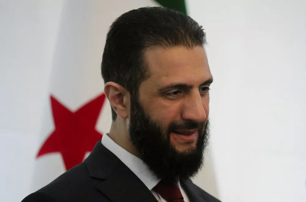 FILE PHOTO: Syria's interim President Ahmed al-Sharaa talks to attendees during a national dialogue, a key milestone in the transition to a new political system after decades of Assad rule, in Damascus, Syria February 25, 2025. REUTERS/Khalil Ashawi/File Photo