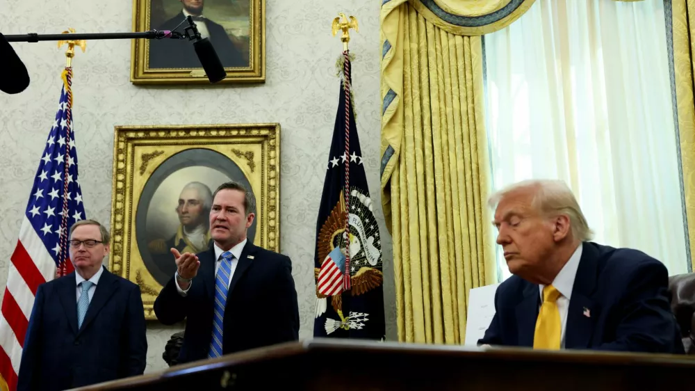 U.S. National Security Advisor Michael Waltz speaks next to U.S. President Donald Trump in the Oval Office of the White House in Washington, D.C., U.S., March 7, 2025. REUTERS/Leah Millis