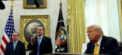 U.S. National Security Advisor Michael Waltz speaks next to U.S. President Donald Trump in the Oval Office of the White House in Washington, D.C., U.S., March 7, 2025. REUTERS/Leah Millis