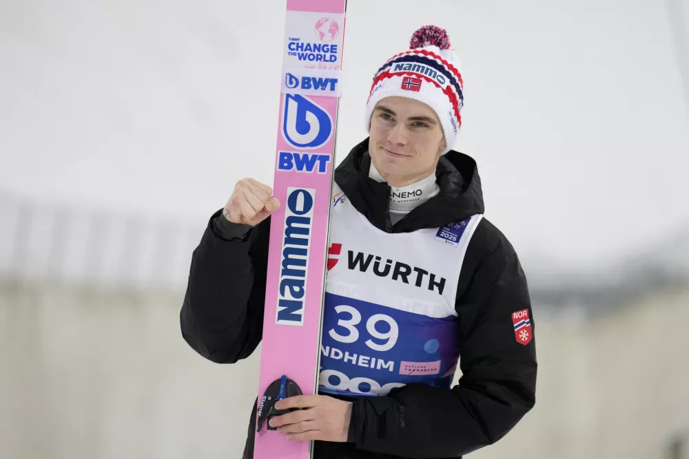 Marius Lindvik, of Norway, poses after winning the silver medal in the ski jumping men's large hill individual competition at the Nordic World Ski Championships in Trondheim, Norway, Saturday, March 8, 2025. (AP Photo/Matthias Schrader)