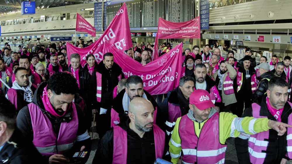 Airport employees organized in the Komba union walk through the airport in Frankfurt, Germany, Monday, March 10, 2025, when all major airports in Germany went on a warning strike. (AP Photo/Michael Probst)