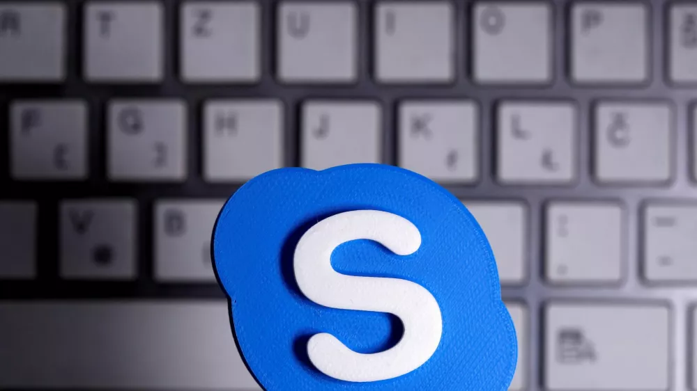 FILE PHOTO: A 3D printed Skype logo is placed in front of a keyboard in this illustration taken April 12, 2020. REUTERS/Dado Ruvic/Illustration/File Photo