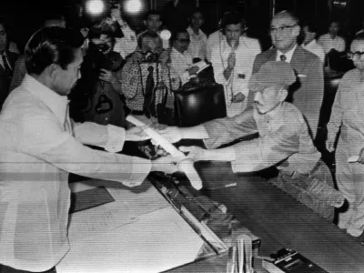 This picture taken on March 11, 1974 shows former Japanese imperial army soldier Hiroo Onoda (R) offering his military sword to former Philippine President Ferdinand Marcos (L) to express his surrender at the Malacanan Palace in Manila. Onoda, who hid in the Philippine jungle for three decades because he did not believe World War II was over, has died in Tokyo on January 17, 2014, at the age of 91. The former soldier waged a guerilla campaign in Lubang Island near Luzon until he was finally persuaded in 1974 that peace had broken out.  JAPAN OUT,Image: 182171991, License: Rights-managed, Restrictions: JAPAN OUT, Model Release: noFoto: Profimedia