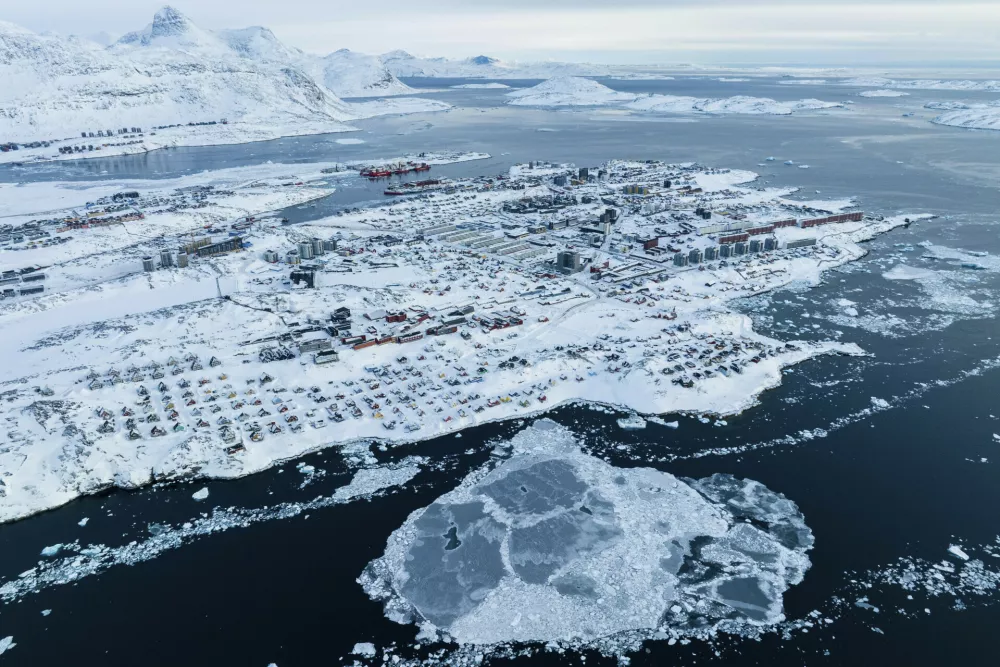 Houses covered by snow are seen on the coast of a sea inlet of Nuuk, Greenland, Friday, March 7, 2025. (AP Photo/Evgeniy Maloletka)