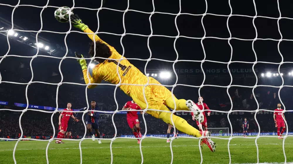 Soccer Football - Champions League - Round of 16 - First Leg - Paris St Germain v Liverpool - Parc des Princes, Paris, France - March 5, 2025 Liverpool's Alisson Becker makes a save REUTERS/Gonzalo Fuentes