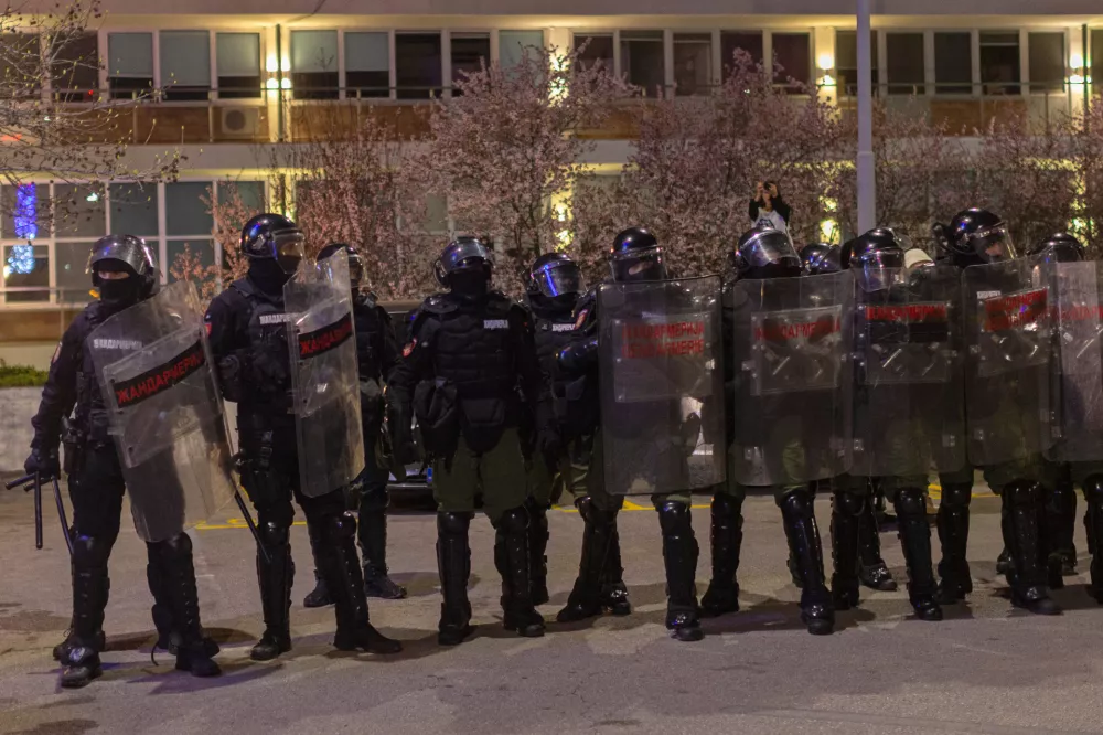 Serbian law enforcement stand as hundreds of students block the public broadcaster RTS building in central Belgrade, Serbia, Tuesday, March 11, 2025. (AP Photo/Marko Drobnjakovic)