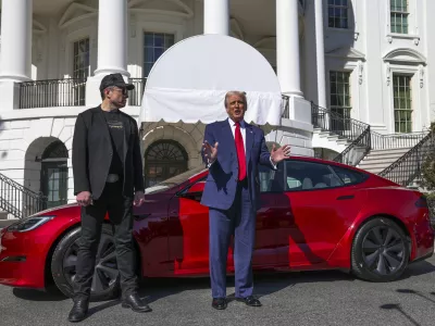 President Donald Trump and Tesla CEO Elon Musk speak to reporters in front of a red Model S Tesla vehicle on the South Lawn of the White House Tuesday, March 11, 2025, in Washington. (Pool via AP)