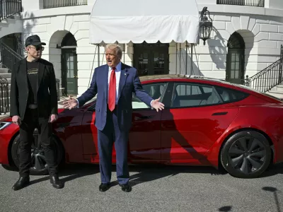 President Donald Trump and Tesla CEO Elon Musk speak to reporters near a red Model S Tesla vehicle on the South Lawn of the White House Tuesday, March 11, 2025, in Washington. (Pool via AP)