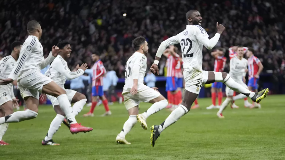 Real Madrid players celebrate after winning the penalty shootout during the Champions League round of 16, second leg, soccer match between Atletico Madrid and Real Madrid at the Metropolitano stadium in Madrid, Spain, Wednesday, March 12, 2025. (AP Photo/Bernat Armangue)