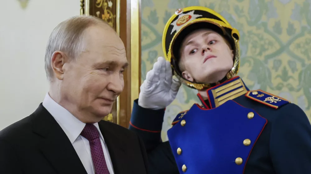 Russian President Vladimir Putin walks past an honor guard prior to a meeting with Belarusian President Alexander Lukashenko at the Grand Kremlin Palace in Moscow, Russia, Thursday, March 13, 2025. (Maxim Shemetov/Pool Photo via AP)