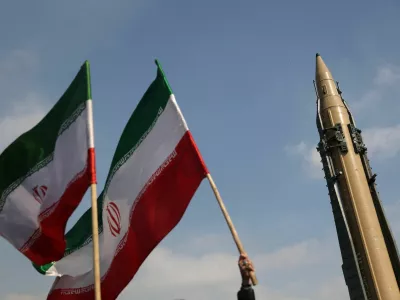 FILE PHOTO: People wave flags next to an Iranian missile on display during the 46th anniversary of the Islamic Revolution in Tehran, Iran, February 10, 2025. Majid Asgaripour/WANA (West Asia News Agency) via REUTERS ATTENTION EDITORS - THIS PICTURE WAS PROVIDED BY A THIRD PARTY/File Photo