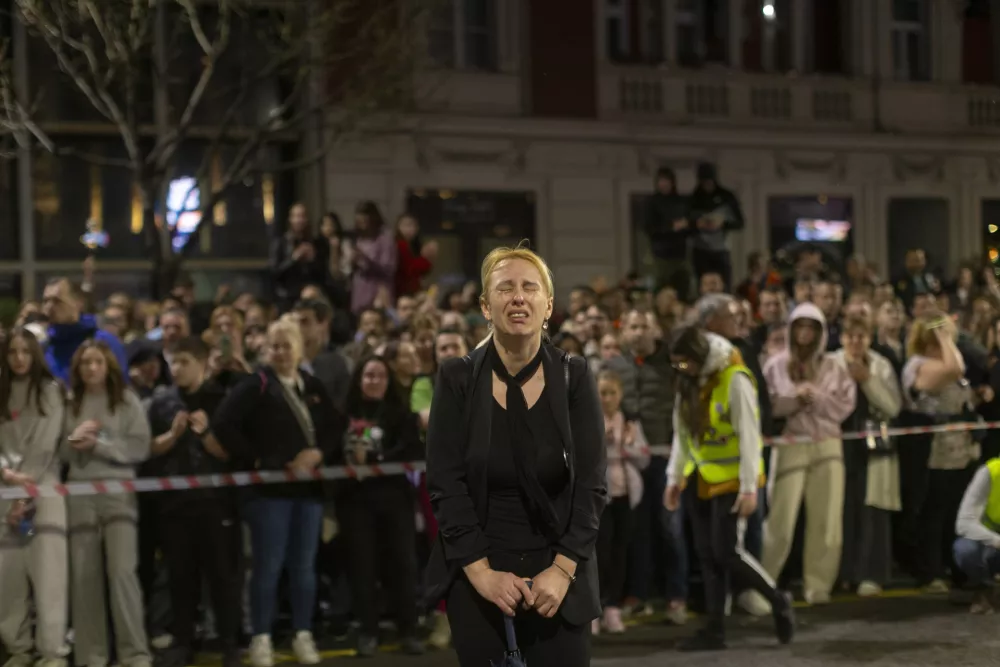 Dijana Hrka, center, mother of a young man killed in a train station canopy collapse, cries as she attends a protest ahead of a major anti-corruption rally this weekend, in Belgrade, Serbia, Friday, March 14, 2025. (AP Photo/Marko Drobnjakovic)