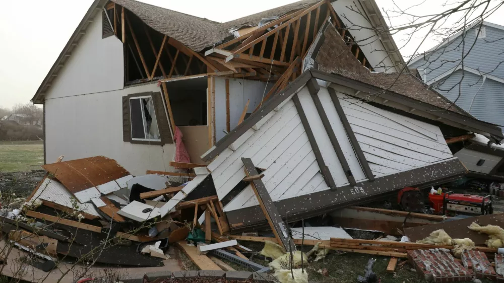 Debris lies around a damaged home the morning after a tornado touched down in Florissant, Missouri, U.S. March 15, 2025. REUTERS/Lawrence Bryant