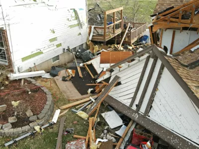 Debris lies around a damaged house the morning after a tornado touched down in Florissant, Missouri, U.S. March 15, 2025. REUTERS/Lawrence Bryant