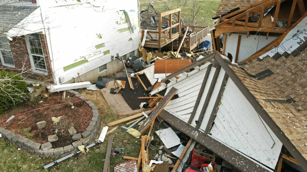 Debris lies around a damaged house the morning after a tornado touched down in Florissant, Missouri, U.S. March 15, 2025. REUTERS/Lawrence Bryant