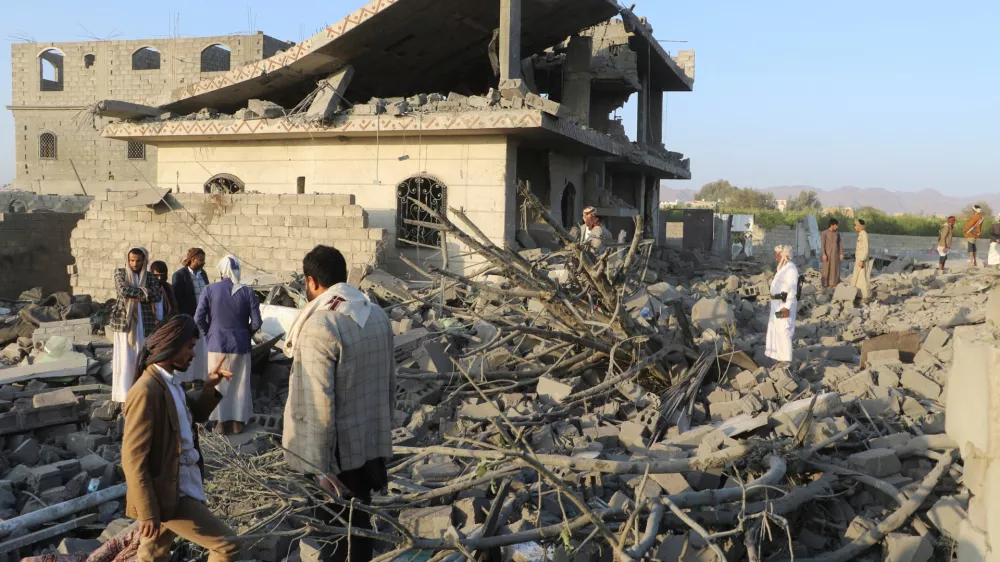 People stand on the rubble of a house hit by a U.S. strike in Saada, Yemen March 16, 2025. REUTERS/Naif Rahma