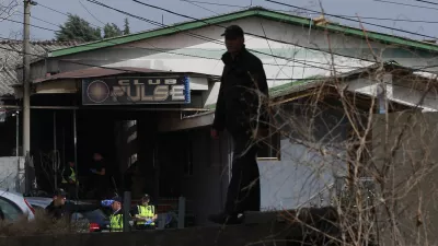 A police officer inspects a nightclub in the town of Kocani, North Macedonia, Sunday, March 16, 2025, following a massive fire in the nightclub early Sunday. (AP Photo/Visar Kryeziu)