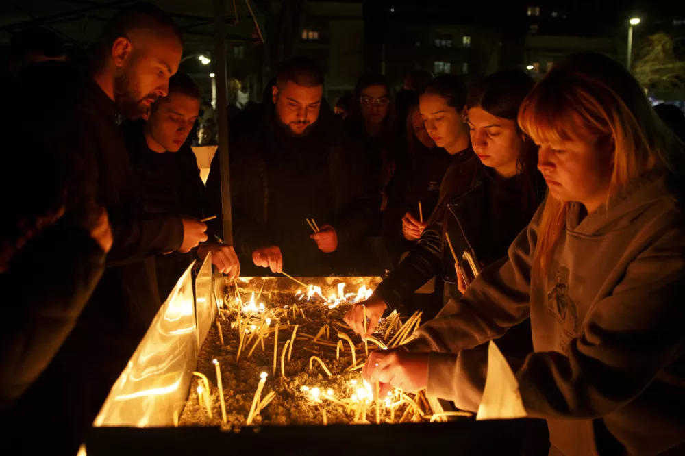 People light candles in the town of Kocani, North Macedonia, Sunday, March 16, 2025, following a massive fire in a nightclub early Sunday. (AP Photo/Visar Kryeziu)